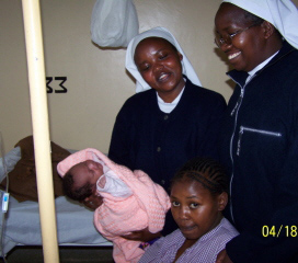 Sr. Lucy and Sr. Christine holding a newborn